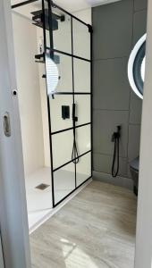 a bathroom with a glass door with a shower at 360 Grad Floating Home Shanti 2 in Gallin