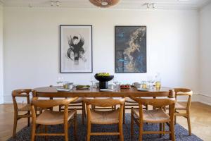 a dining room with a wooden table and chairs at 3 Bedroom Flat in Lovely Area in Copenhagen