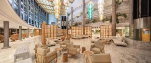 a lobby with couches and chairs in a building at Maspalomas Princess in Maspalomas
