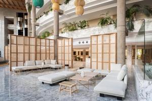 a lobby with white couches and tables at Maspalomas Princess in Maspalomas