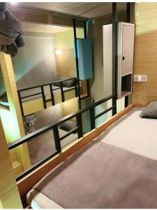 a room with two bunk beds and a mirror at SUSU khaosan hostel in Bangkok