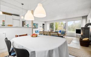 a kitchen and living room with a white table and chairs at 3 Bedroom Gorgeous Home In Vejby in Vejby