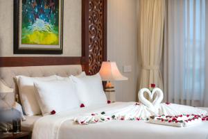 a bedroom with a bed with a heart decoration on it at Thien Thai Hotel & Spa in Hanoi