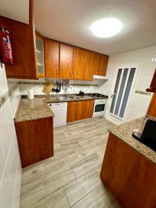 a kitchen with wooden cabinets and wooden floors at Cabo de palos subida al faro in Cabo de Palos +11 photos