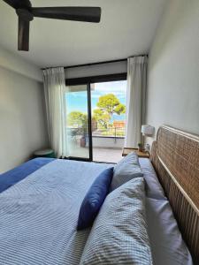 a bedroom with a bed with a large window at BONAVISTA PLATJA BEGUR in Begur