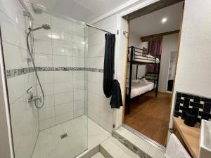 a bathroom with a walk in shower and a bedroom at Chambre Le 40 marches in Cucugnan