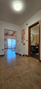an empty living room with a large room with a mirror at Apartment Bluemare B6 with Shared Pool in Ližnjan
