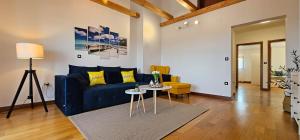 a living room with a blue couch and a table at Apartment Bluemare B6 with Shared Pool in Ližnjan