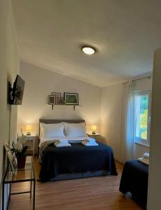 Postel nebo postele na pokoji v ubytování Apartments Curnić