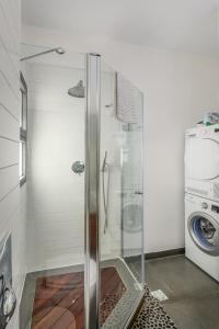 a shower in a bathroom with a washing machine at Modern & Sunny 1 BDR w balcony and parking in Tel Aviv