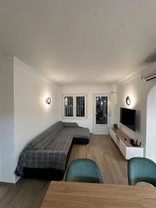 1 dormitorio con 1 cama, TV y sillas en OLIVA NOVA GOLF BEACH & RESORT Club Sevilla VI 3A, en Oliva