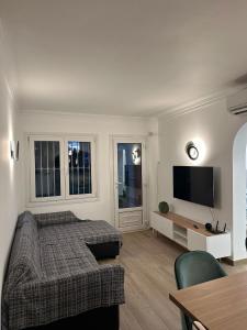 sala de estar con cama y TV de pantalla plana en OLIVA NOVA GOLF BEACH & RESORT Club Sevilla VI 3A, en Oliva