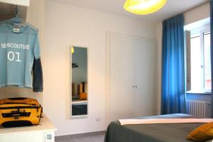 a bedroom with a bed and a mirror and a bag at Vichi's nest in Pianello Del Lario