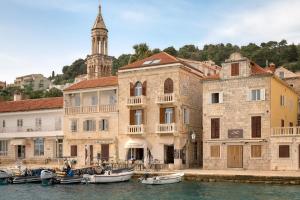 a building with boats docked in the water next to buildings at Apartment Mama Marija in Hvar