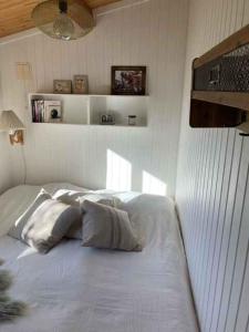a white bed with four pillows in a room at Lovely Holiday Home With Annex And Garden, in Dronningmølle