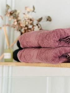 a pile of pink towels sitting on a shelf at The Old Hotel Silkeborg - 1TH in Silkeborg