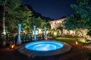 a swimming pool in the middle of a yard at night at B&B Il Casale di Monserrato in Porto Azzurro