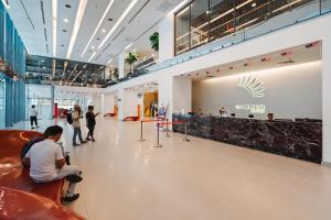 a lobby of a shopping mall with people sitting at Summer Suites KLCC Apartments by soulasia in Kuala Lumpur