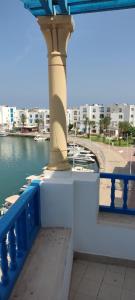 a bridge over a body of water with a building at Appartement de luxe au coeur de la marina Hammamet in Hammamet