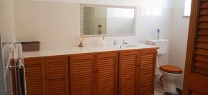 a bathroom with a sink and a toilet at Stay on the Bay in Gqeberha