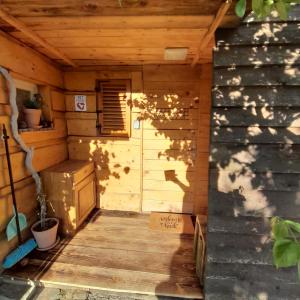 an outside view of a wooden cabin with a porch at Glamping pod Hrastom in Dramlje