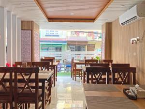 a dining room with wooden tables and chairs at Hotel Lumbini Airport in Kathmandu