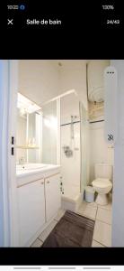 a white bathroom with a sink and a toilet at Mazet 5 pers plage parking gratuit wifi clim in La Londe-les-Maures