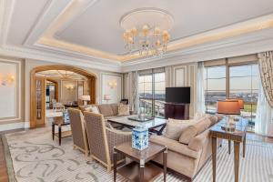 a living room with a couch and a table at Al Habtoor Palace - Preferred Hotels & Resorts in Dubai
