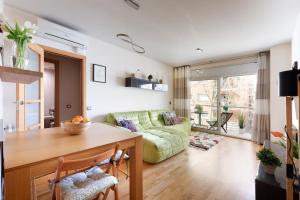 uma sala de estar com uma mesa e um sofá em Beach-line family apartment Barcelona em Barcelona