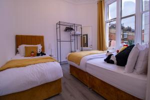 a bedroom with two beds with stuffed animals on them at Prestigious Apartment on Oxford Street - 3 Bedroom 7GC in London