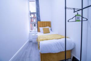 a small bedroom with a bed and a window at Prestigious Apartment on Oxford Street - 3 Bedroom 7GC in London