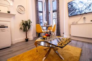 a living room with a chess board on a table at Prestigious Apartment on Oxford Street - 3 Bedroom 7GC in London