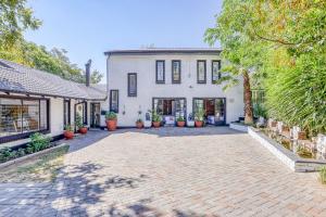 a house with a brick driveway in front of it at The Bedford Manor in Centurion