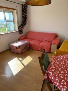 uma sala de estar com um sofá vermelho e uma mesa em Ranjeet felizarda em Lisboa