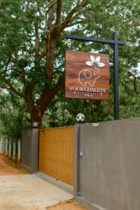 a sign for a four charters way behind a fence at Four Chalets Yala in Tissamaharama