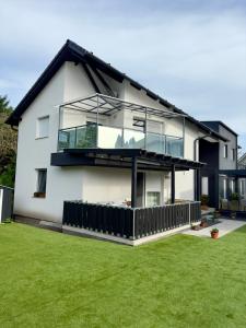 a large white house with a large window at Moonlight Apartment in Siófok