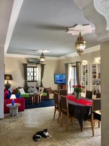 ein Wohnzimmer mit einem Tisch und einer Katze auf dem Boden in der Unterkunft VILLA ALWAN BARAKA - Sans vis à vis, Piscine chauffée, Hammam, Personnel in Essaouira