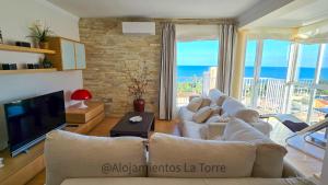 a living room with a couch and a tv at Luxury House Relax - Alojamientos La Torre in Torre del Mar