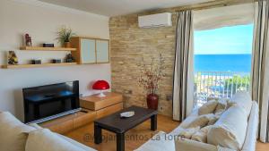 a living room with a couch and a television at Luxury House Relax - Alojamientos La Torre in Torre del Mar