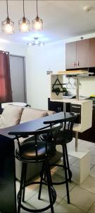 a table and chairs in a room with a bed at HeRo's Lair - Staycation near EK with Ps4 & more! in Santa Rosa +17 photos