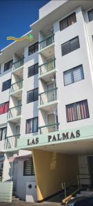 un gran edificio blanco con el nombre de las palmas en HeRo's Lair - Staycation near EK with Ps4 & more! en Santa Rosa