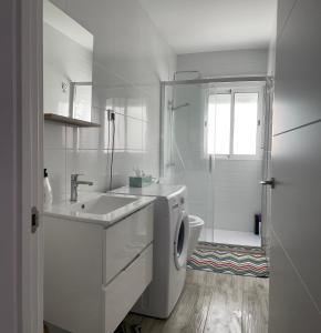 biała łazienka z umywalką i pralką w obiekcie Home Jv 1 w mieście Getafe