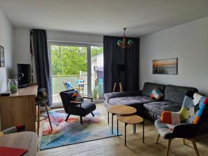 a living room with a couch and chairs at Ferienwohnung Ostseegras Markgrafenheide, 350m bis zur Ostsee, unweit von Warnemünde in Rostock