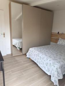 a bedroom with a large bed and a closet at Maison proche Paris. in Saint-Denis