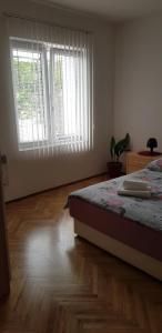 a bedroom with a bed and a large window at Apartment JANDA - Zadar Croatia in Zadar