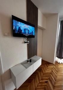 a living room with a tv on the wall at Apartman RISTIC in Vranje