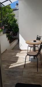 a table and two chairs sitting next to a table at Apartment JANDA - Zadar Croatia in Zadar