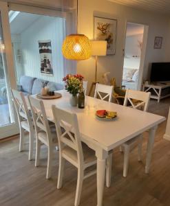 a white table and chairs in a living room at Lovely Summer House In Tranquil Nature, in Ebeltoft