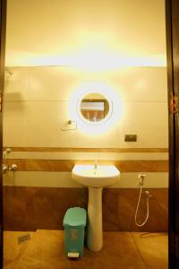 a bathroom with a sink and a mirror at Boats N Beds in Alleppey