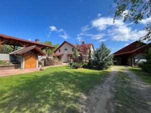 a person standing in the yard of a house at Bozsity Vendégház in Üllés